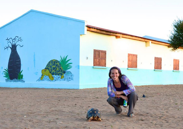 Corrin in remote Madagascar with the rare radiated tortoise, in front of a newly erected school in a village where no school had ever previously existed.