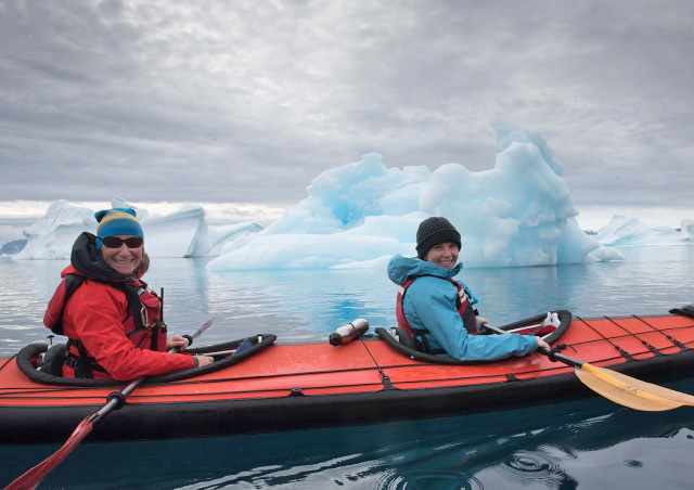 Kayaking among the icebergs in Greenland. Photo credit: Colby Brokvist