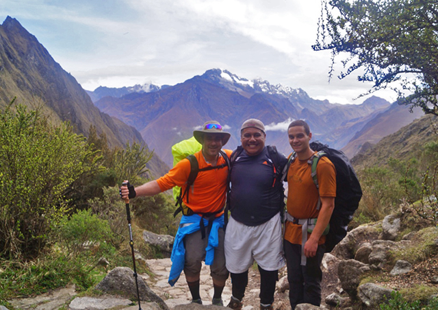 Hiking up the first ascent along the Inca trail from Cusco to Machu Picchu in Peru, with Veronica peak in the background.