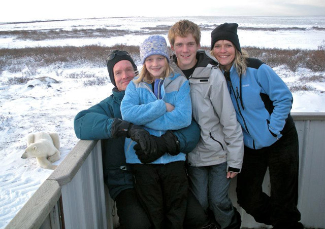 My family enjoying a Classic Polar Bear Adventure in Churchill, on the viewing platform aboard our Polar Rover vehicle. Note who's resting on the ground to our left.