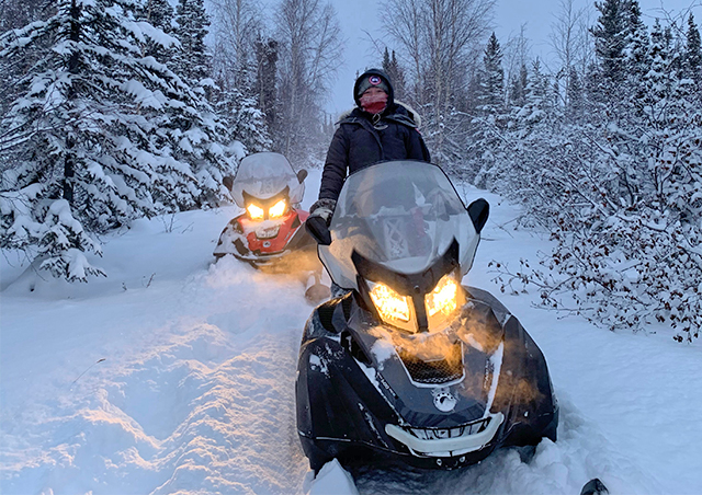Snowmobiling 100km north of Yellowknife NWT in the remote boreal forest