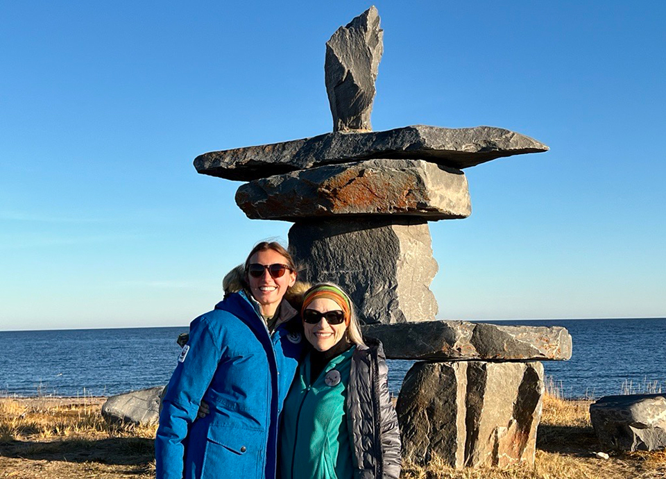 Brittany and Cheryl in front of an Inuit Inukshuk.