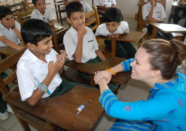 Corrin administering an environmental education program in Bangladesh.