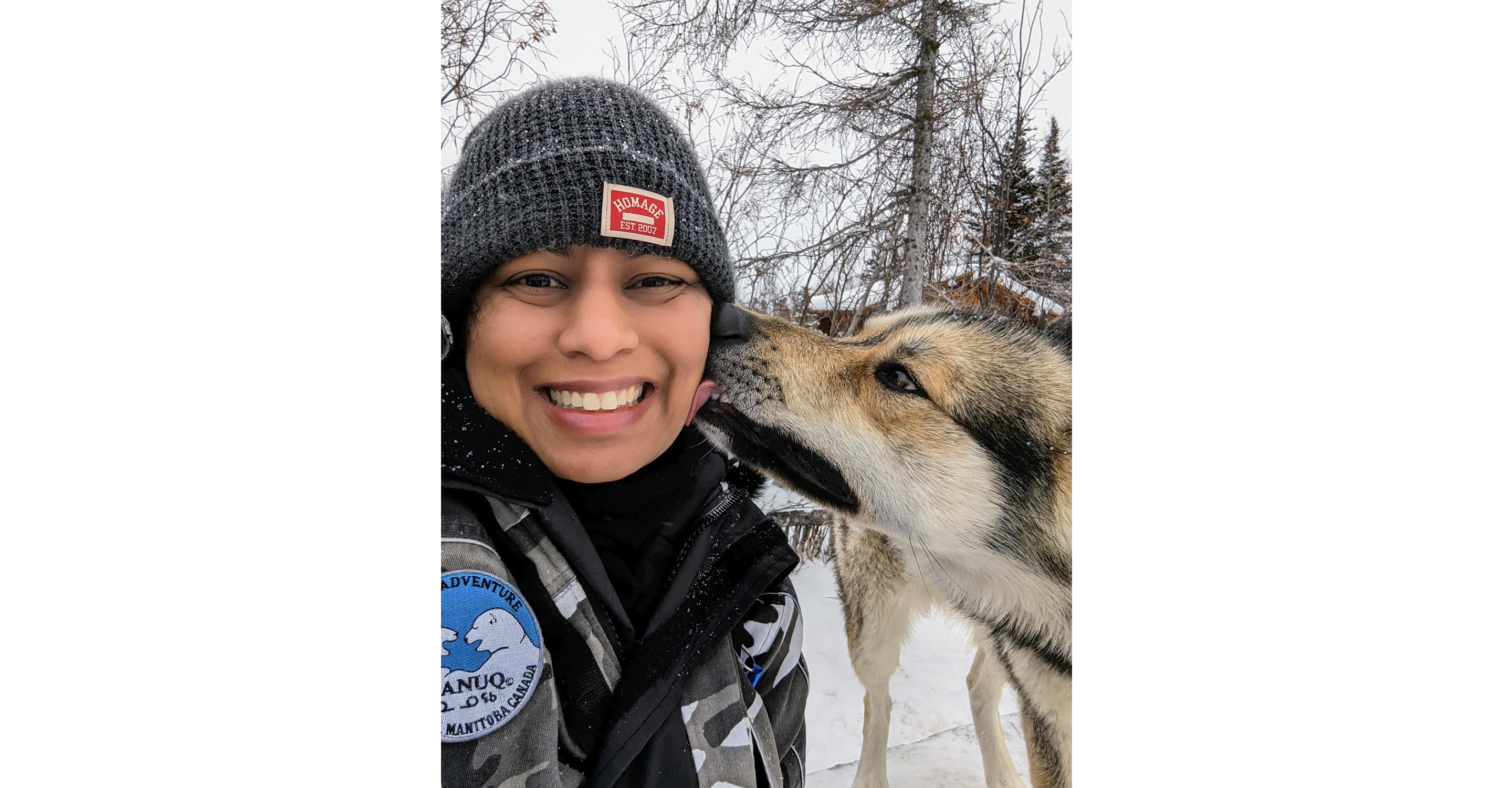 Playing with one of the dogs at Wapusk Adventures, an Indigenous-owned dog sledding/cultural tour company in Churchill, Manitoba, 2023.