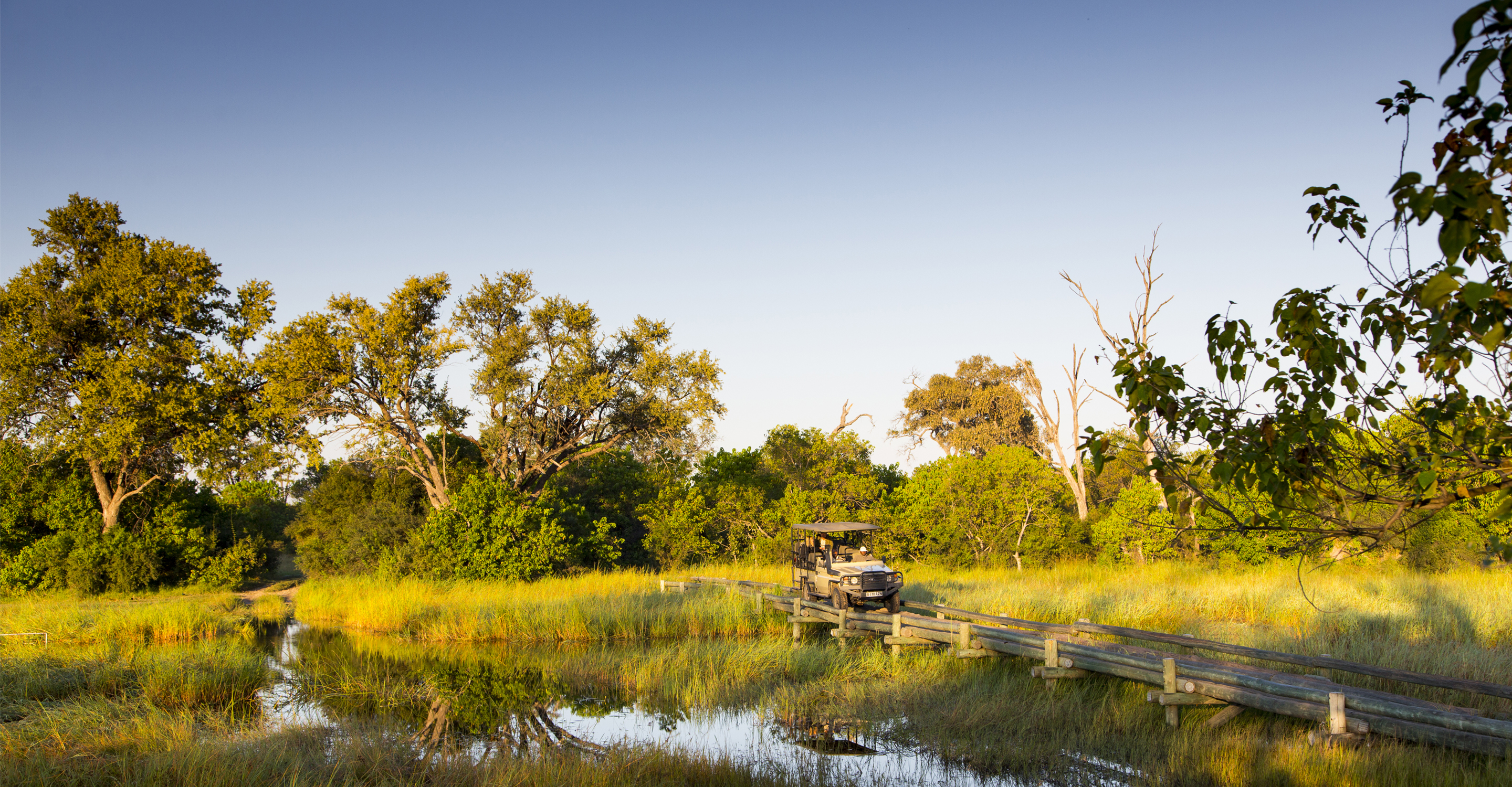 African safari truck on a bridge in the Okavango Delta, Botswana