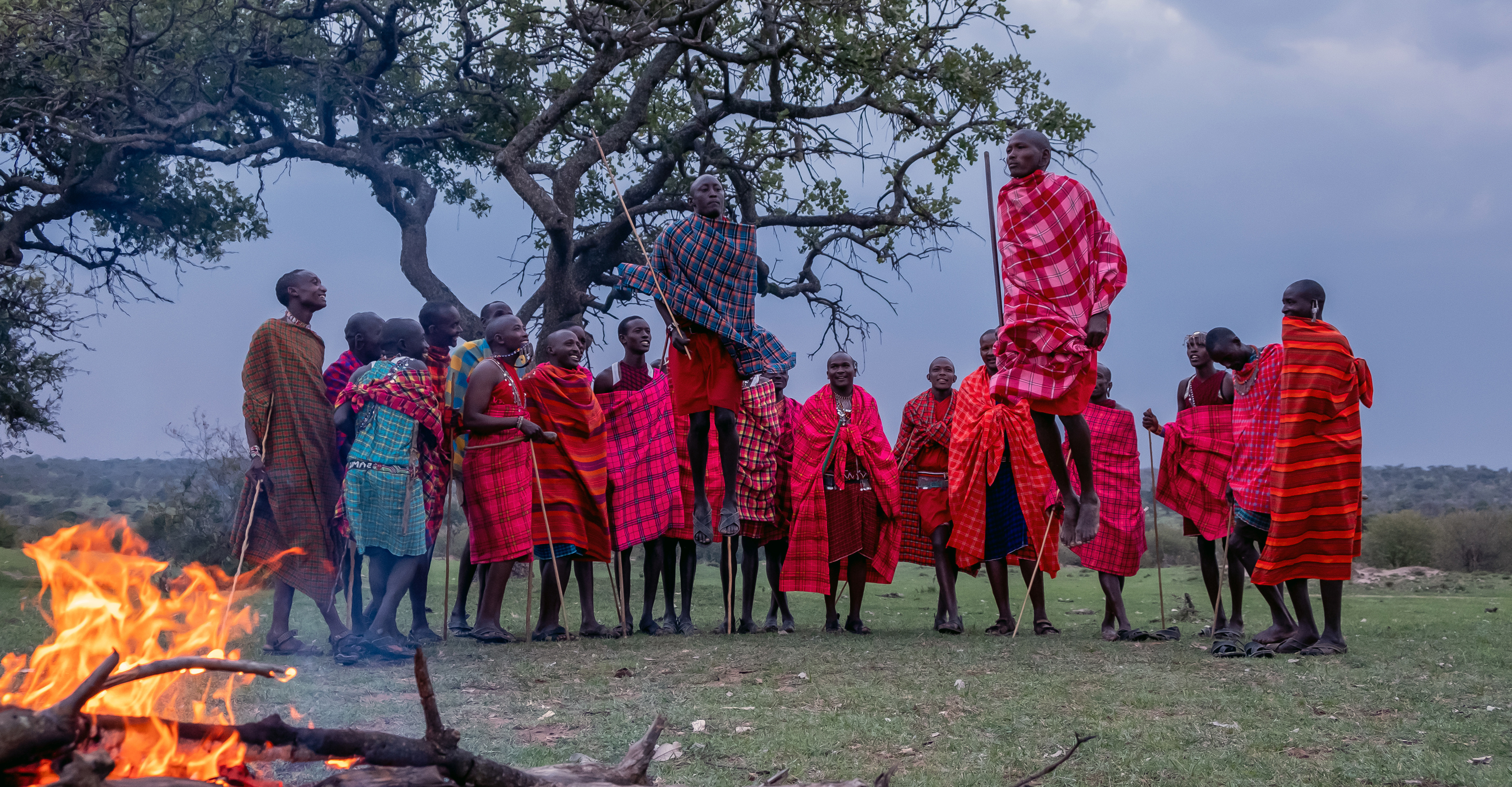 Maasai warriors perform a demonstration near a campfire in the Maasai Mara National Reserve, Kenya