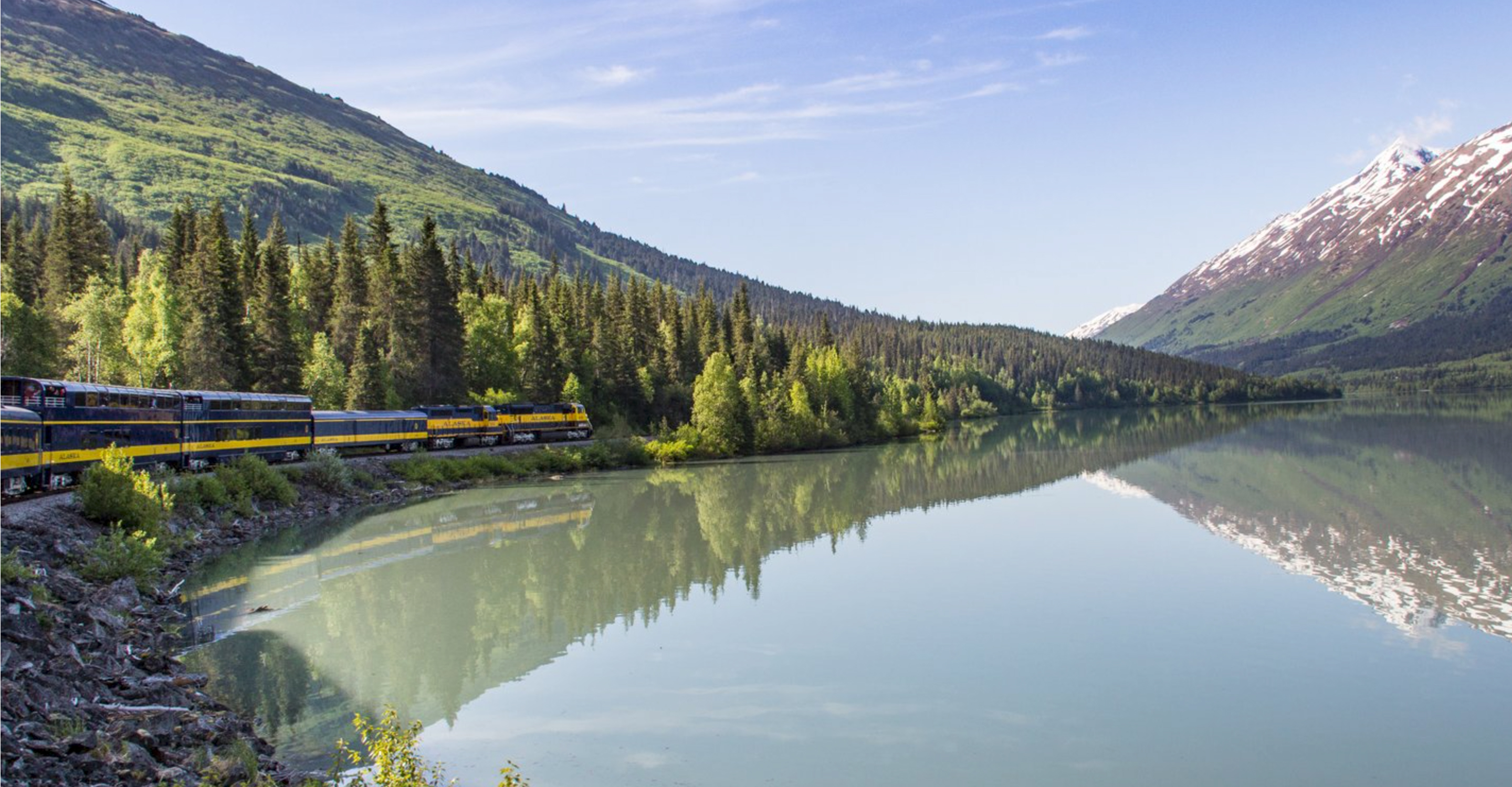 The Alaska Railroad train chugs through the Placer River Valley, Chugach Range, Alaska, USA