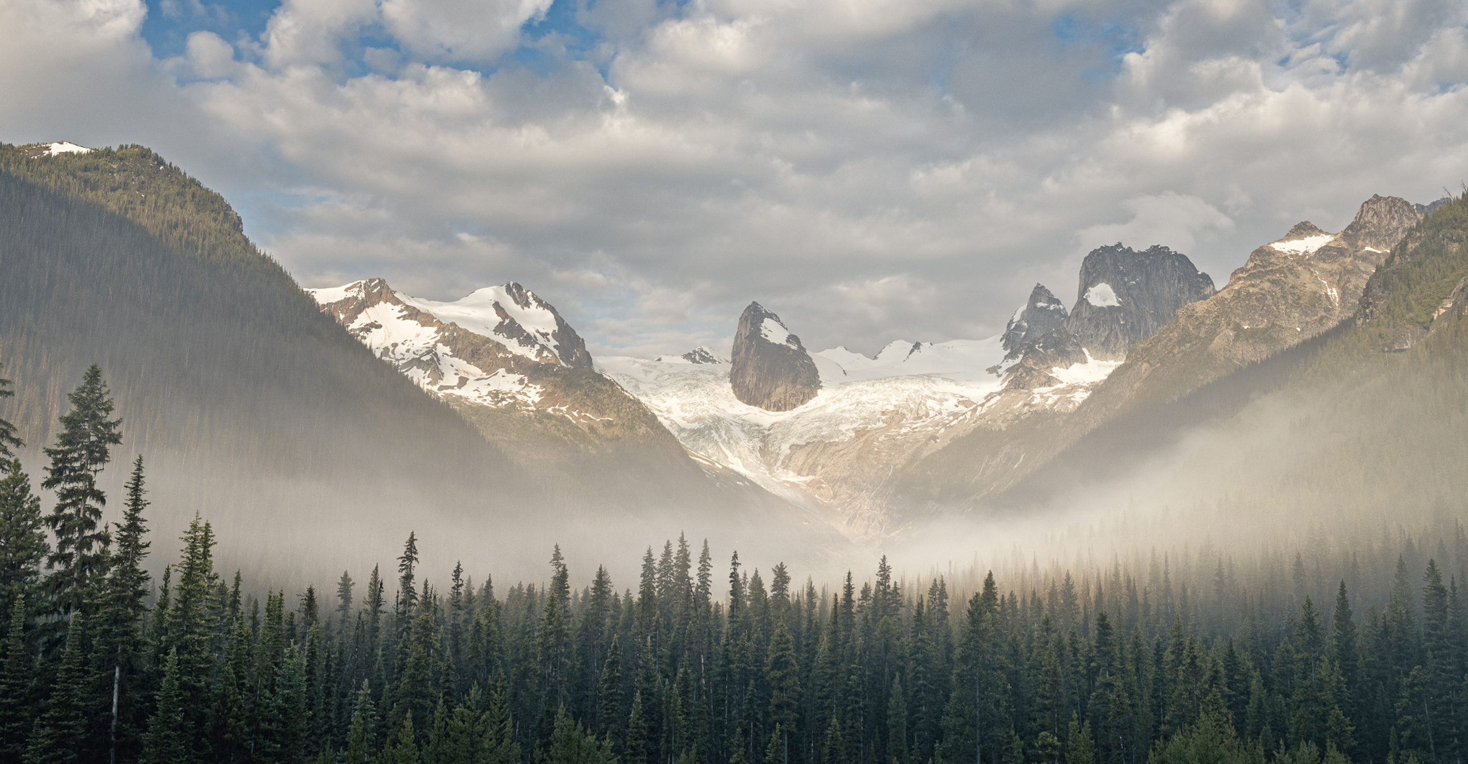A misty valley in front of a glacier, Alberta, Canada