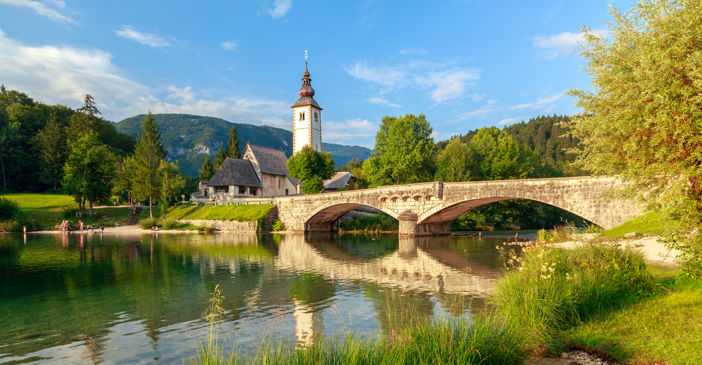 Church of Saint John the Baptist with a bridge over Bohinj Lake, Slovenia