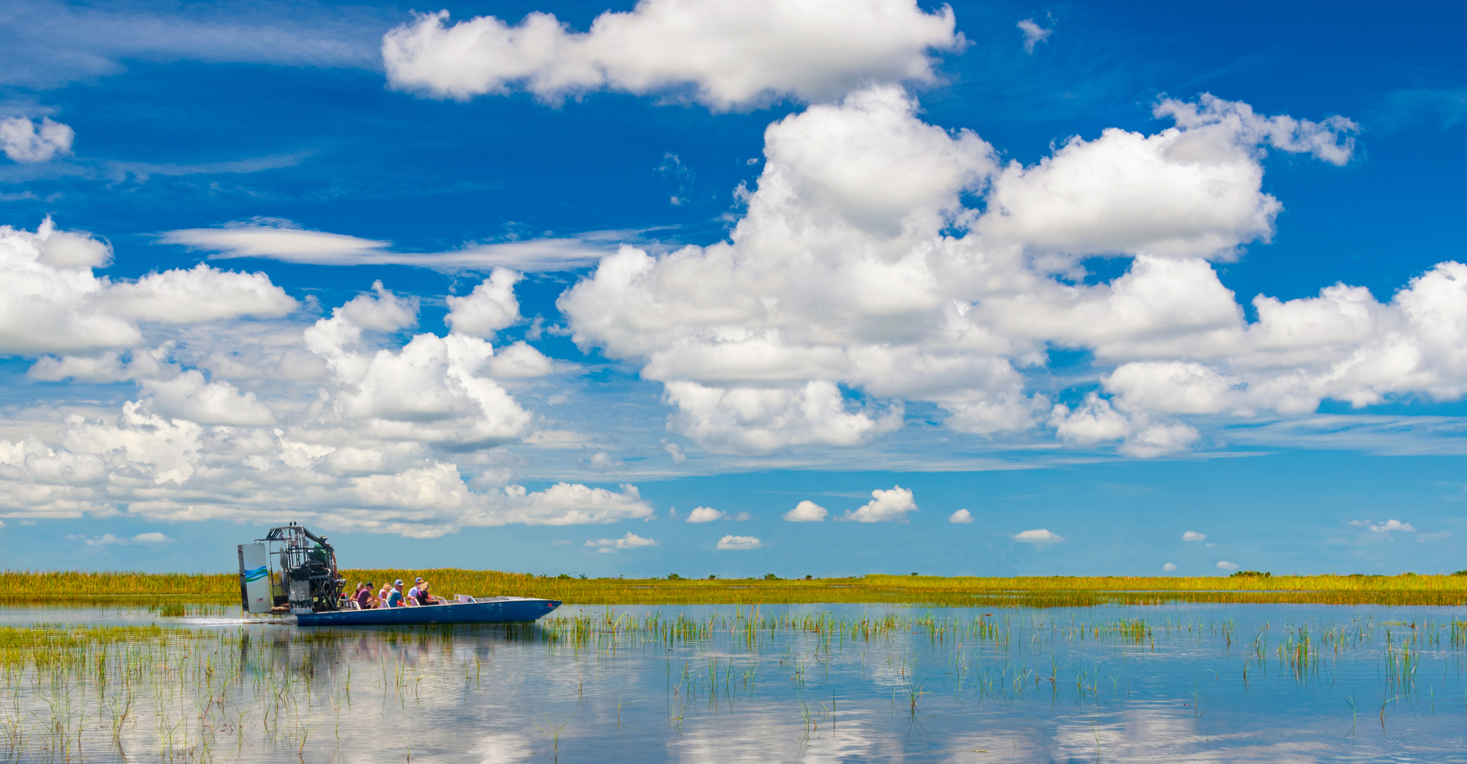 People riding in an airboat in the Everglades National Park, Florida, United States