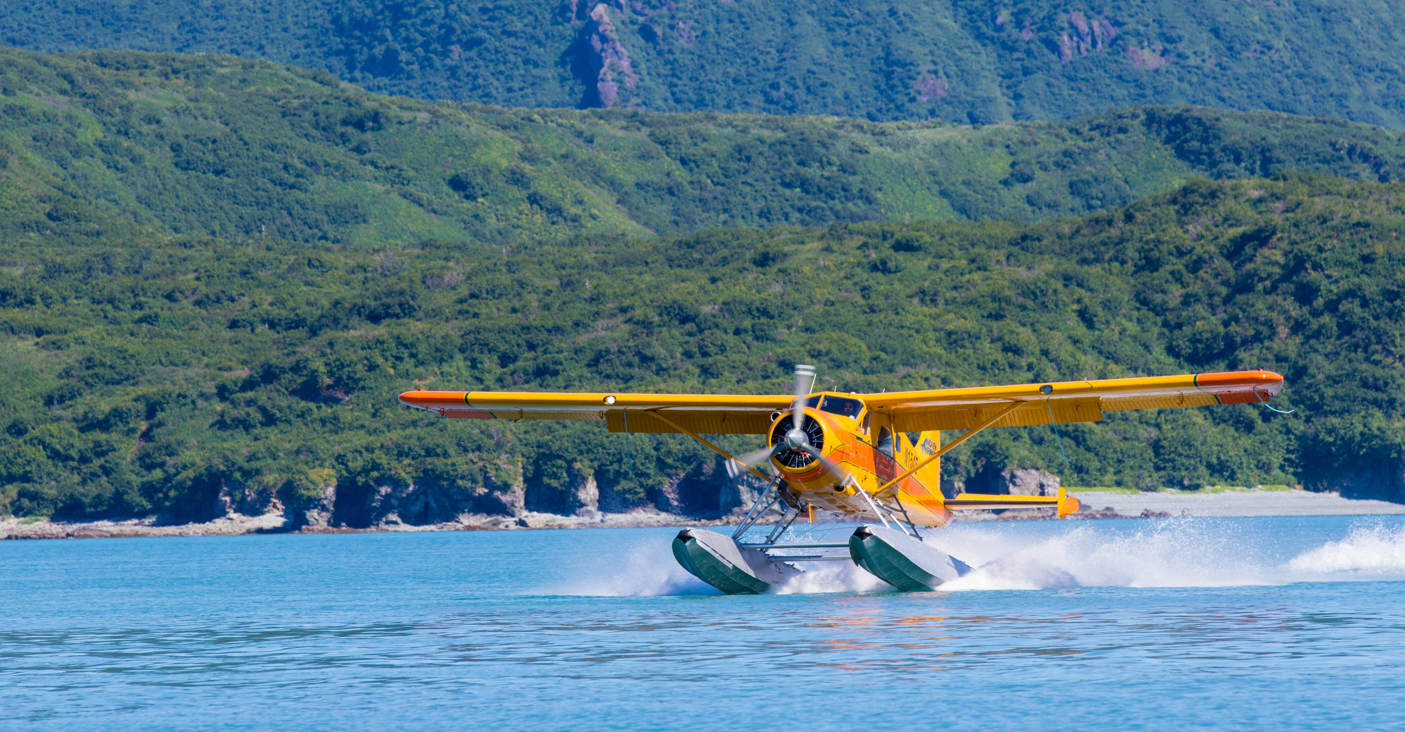 A seaplane takes off from the water in Katmai National Park, Alaska, USA