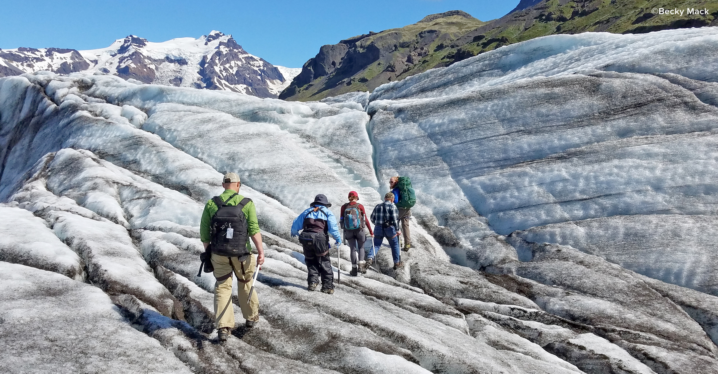 Travelers hike on a glacier in Skaftafell National Park, Iceland, Europe