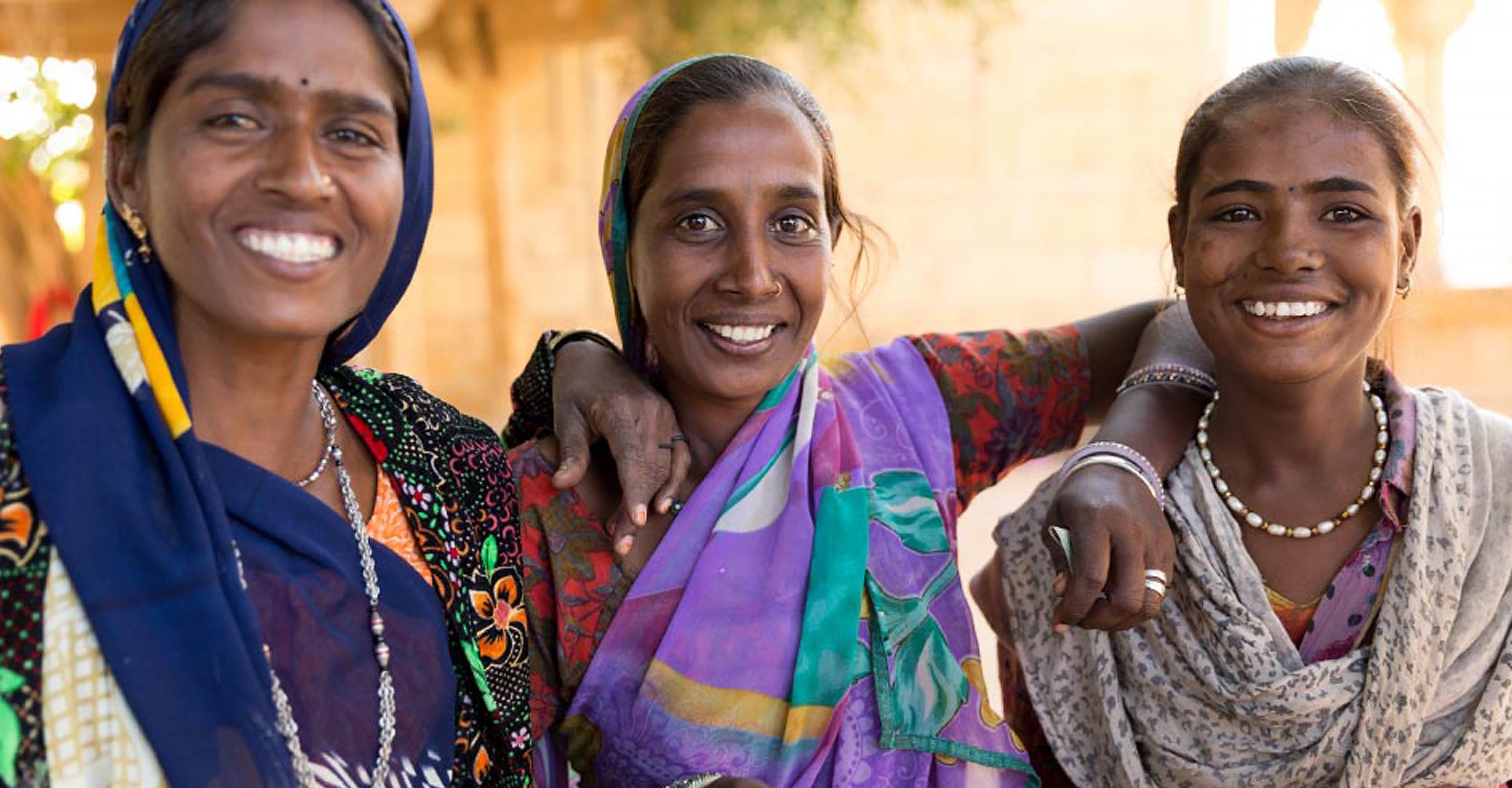 Three Indian women smiling for the camera, India