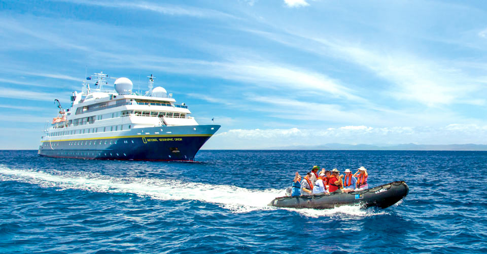 Travelers ride a zodiac away from the National Geographic Orion, Fiji, South Pacific