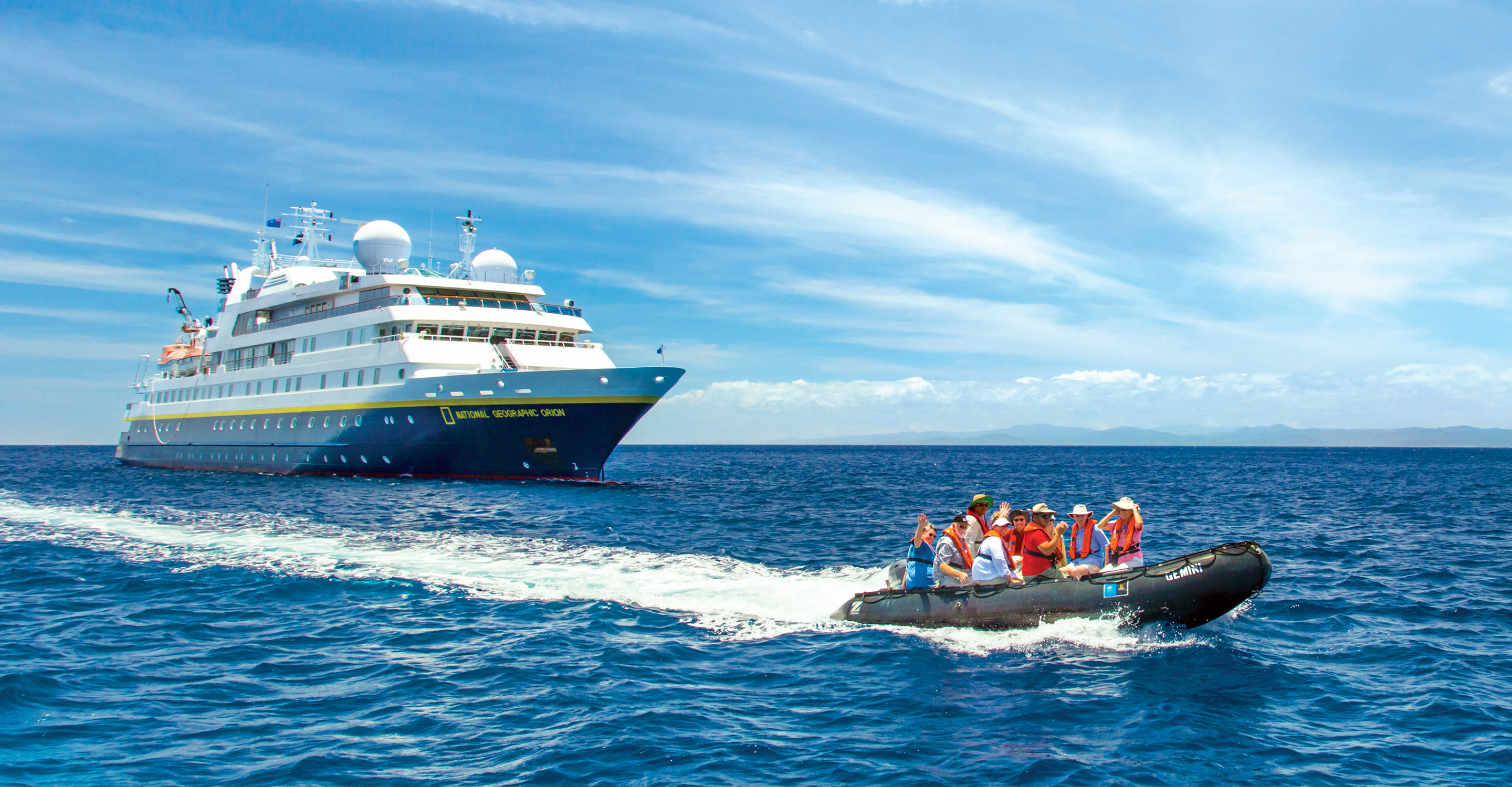 Travelers ride in a zodiac near the National Geographic Orion, South Pacific