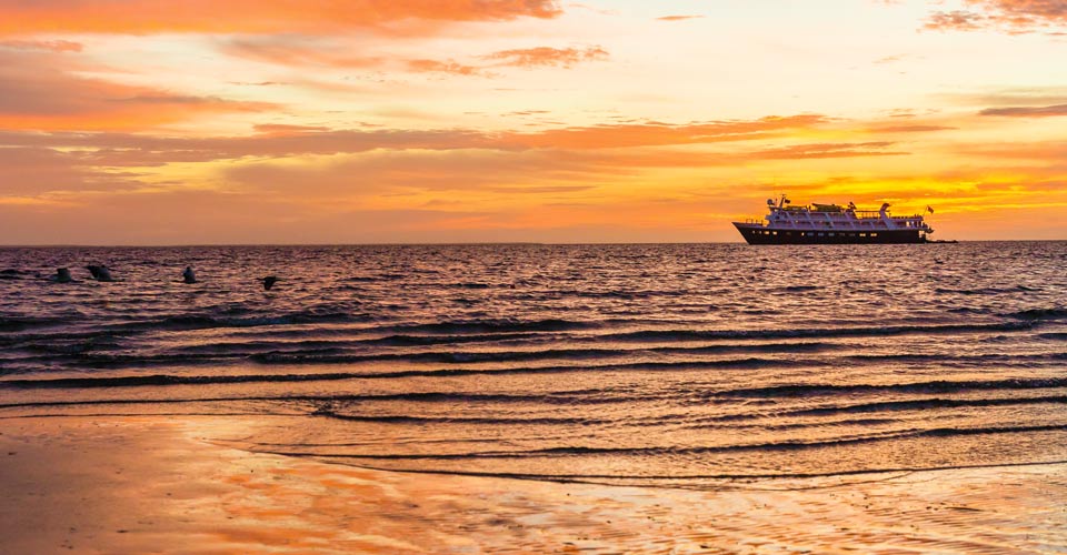 National Geographic Sea Bird anchored offshore at sunset, Baja California Sur, Mexico