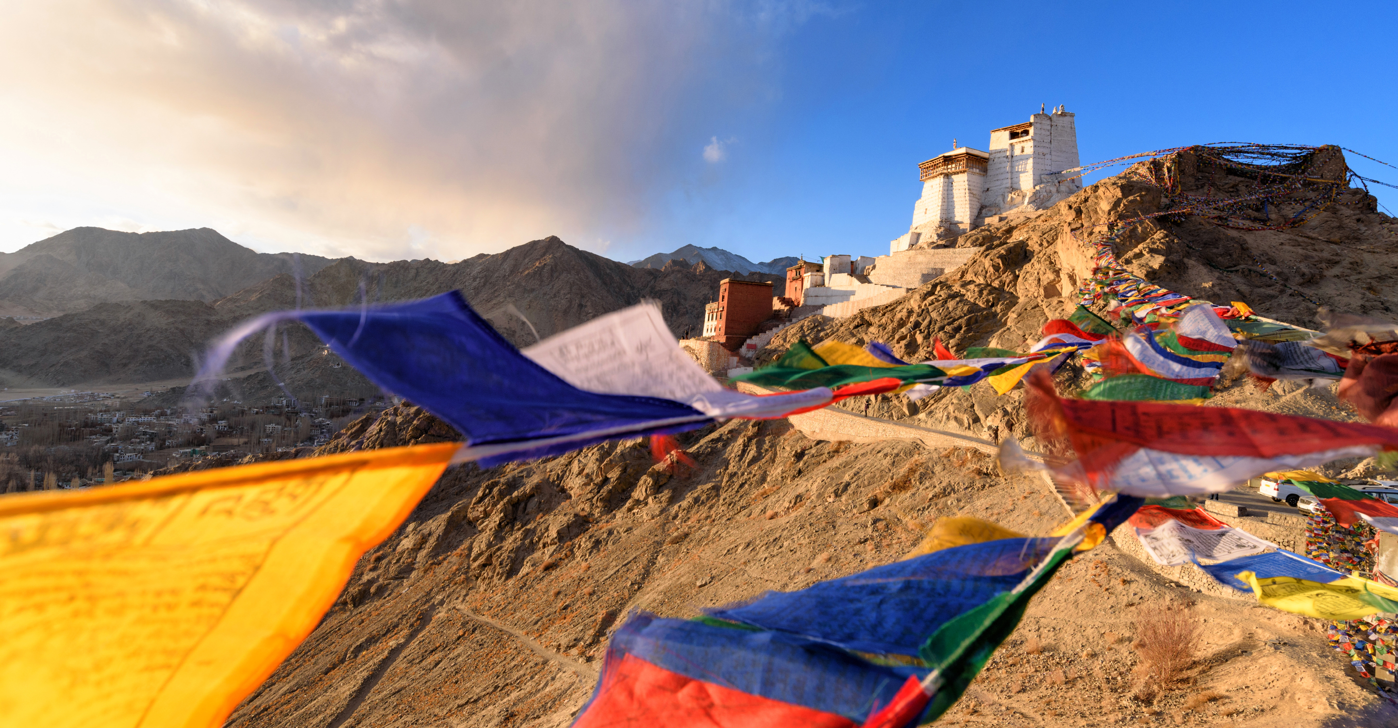 Prayer flags wave in the wind outside of Tsemo Monastery in Ladakh, India
