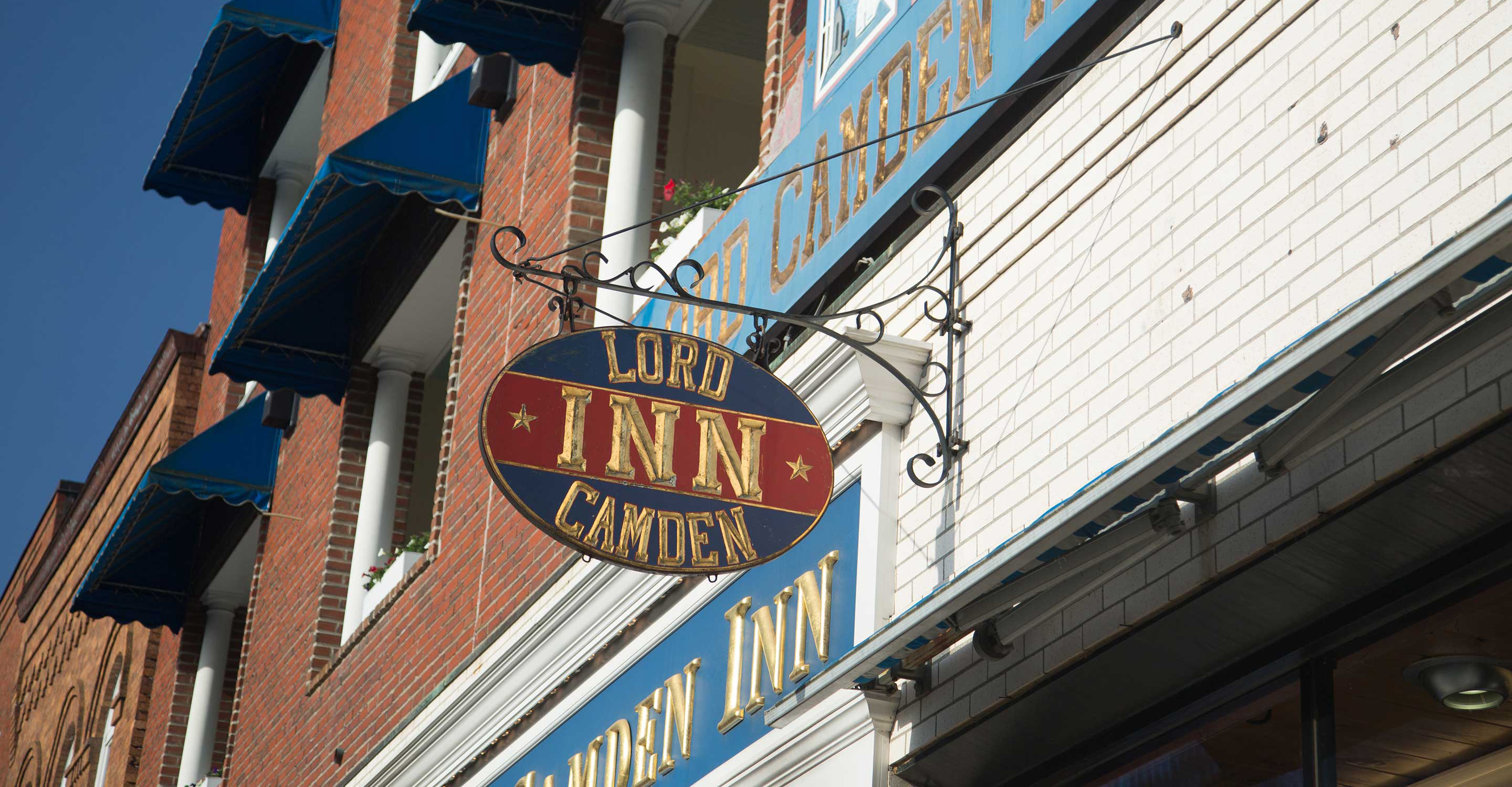 A sign hangs outside The Lord Camden Inn hotel in Camden, Maine, USA