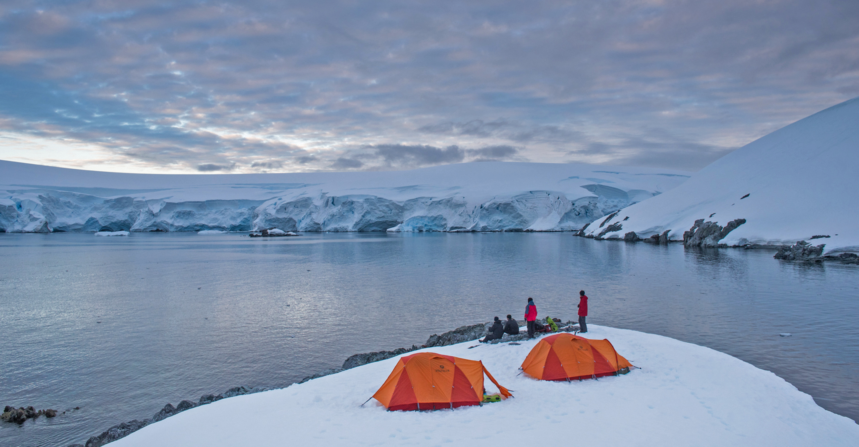 Natural Habitat Adventures travelers camp in the snow in Antarctica