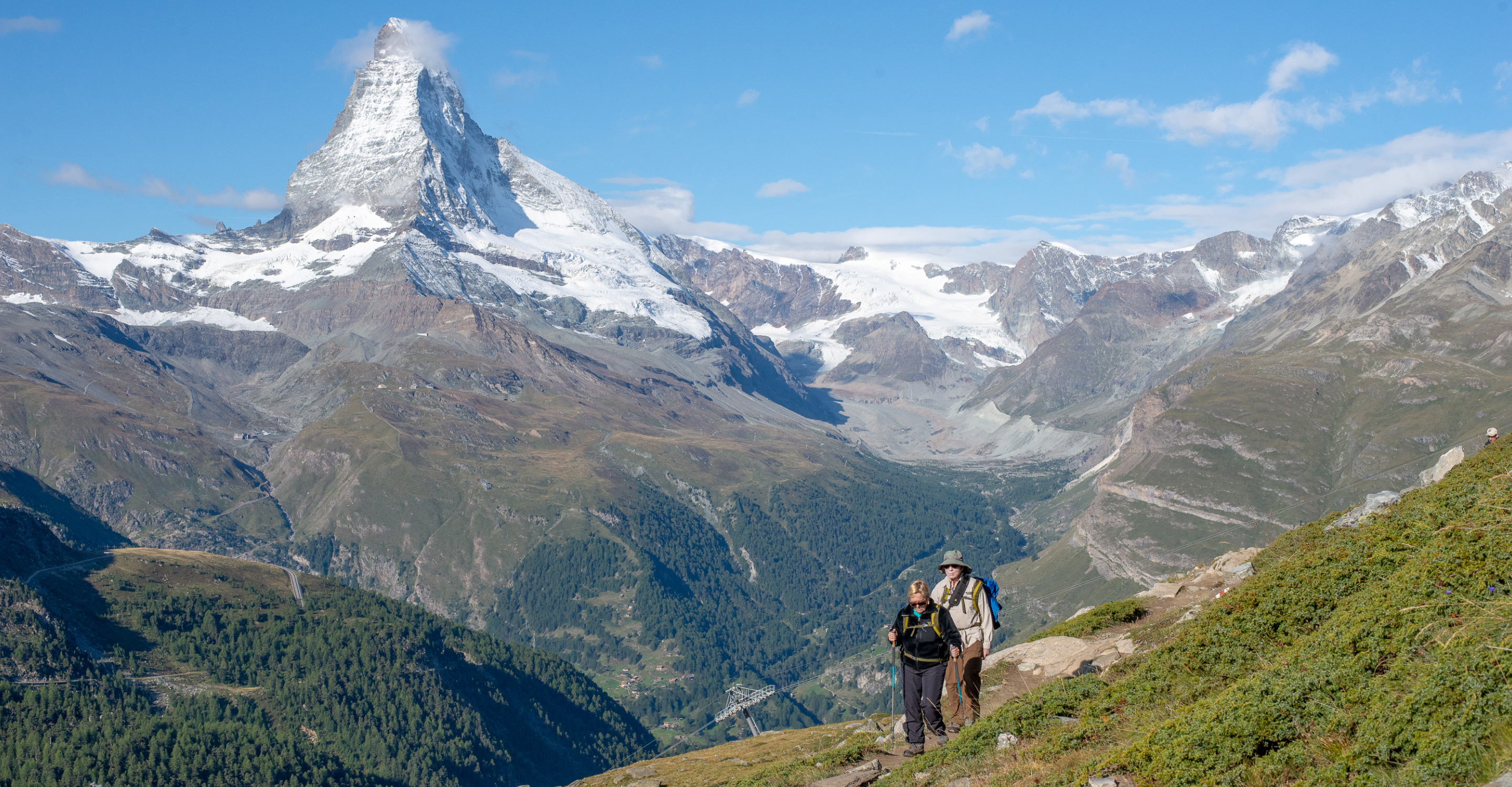 Natural Habitat Adventures travelers hike a trail that overlooks the Matterhorn mountain, Switzerland