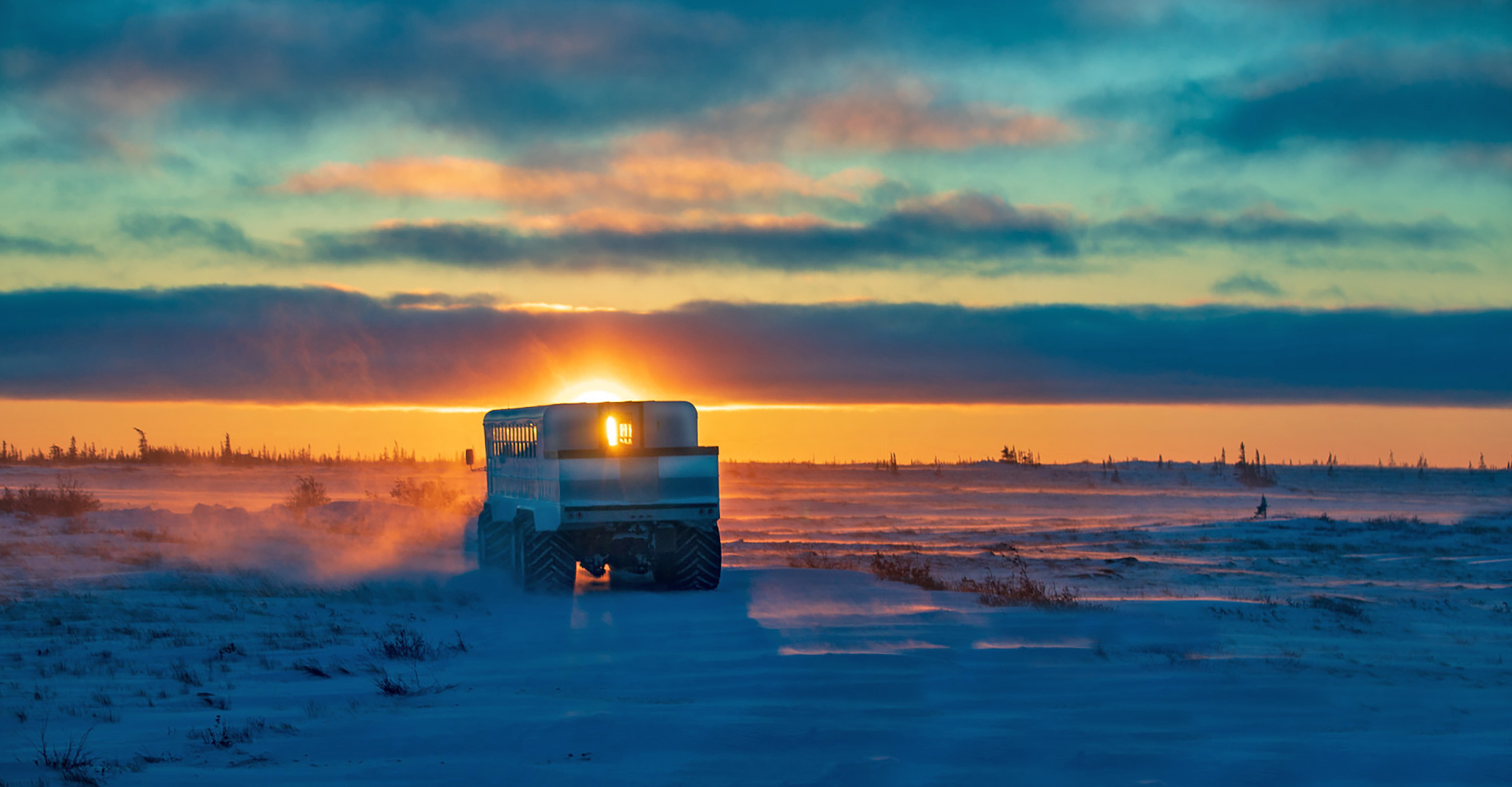A Polar Rover drives over the tundra at sunset, Churchill, Manitoba, Canada