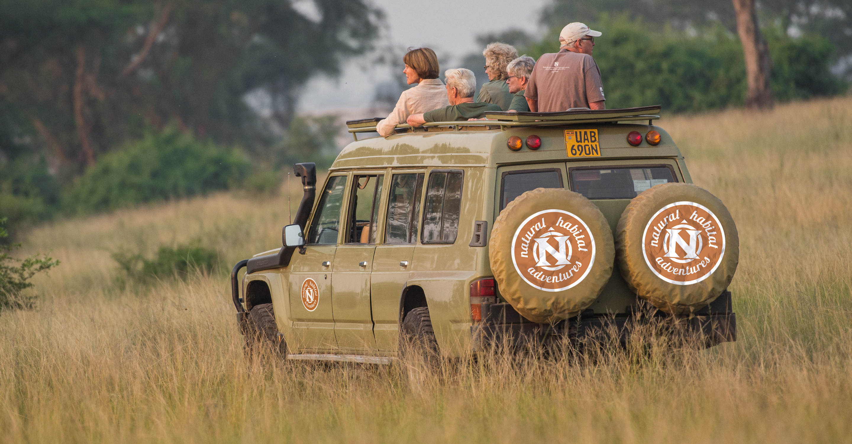 Natural Habitat Adventures travelers view wildlife from their safari vehicle in Queen Elizabeth National Park, Uganda