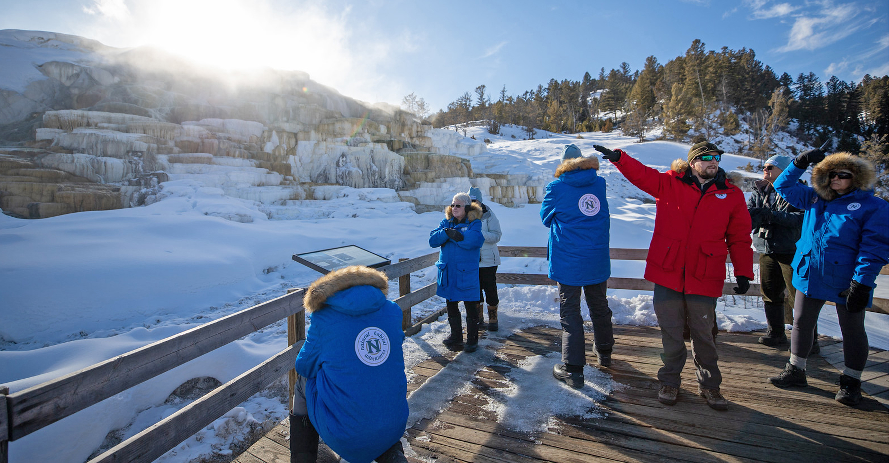 Guide speaks to travelers at Mammoth Hot Springs travertine steps in Yellowstone National Park, United States
