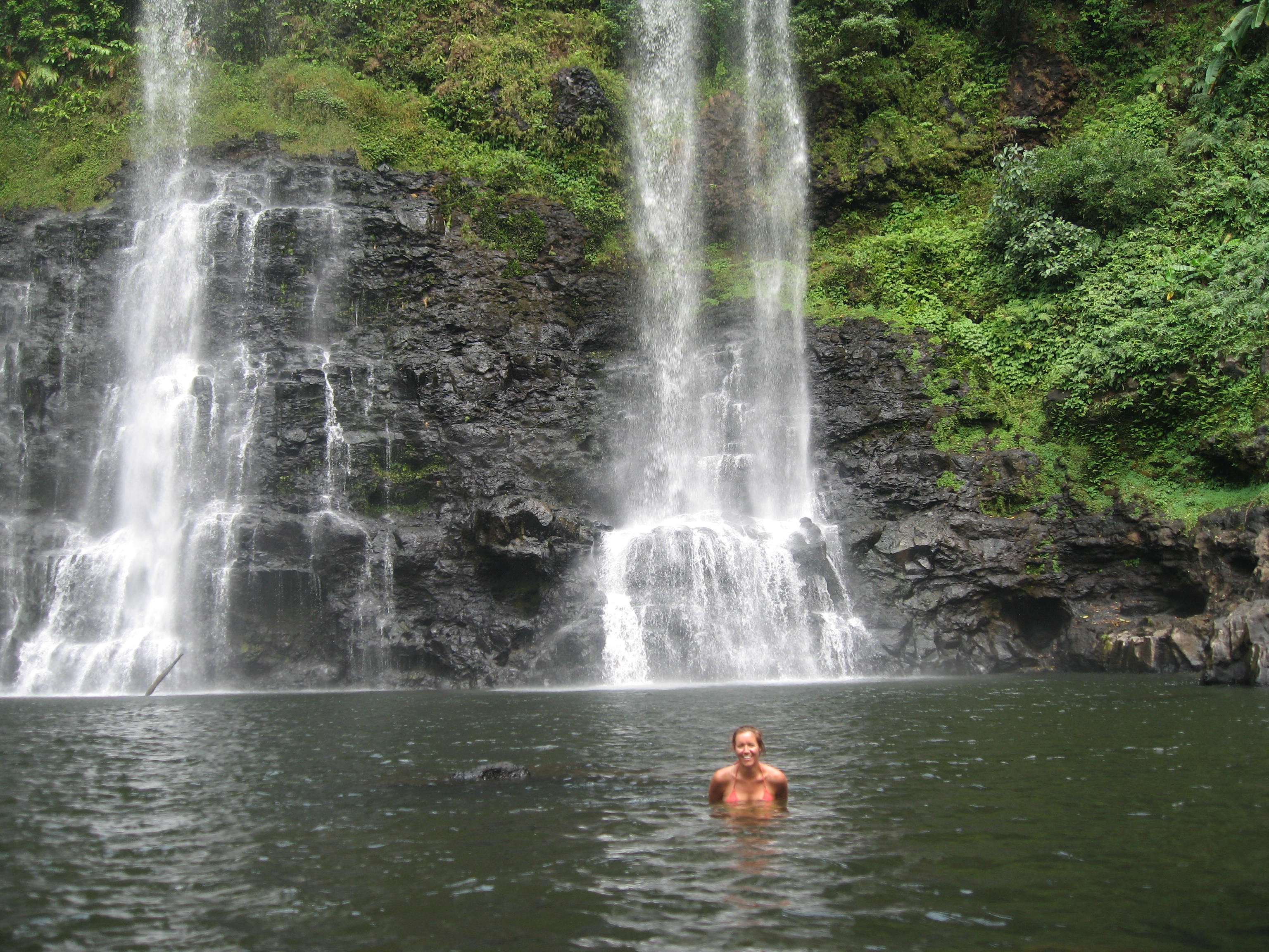 Cooling off from my motorbike ride with a quick dip in a local waterfall in the Bolaven Plateau, Laos.